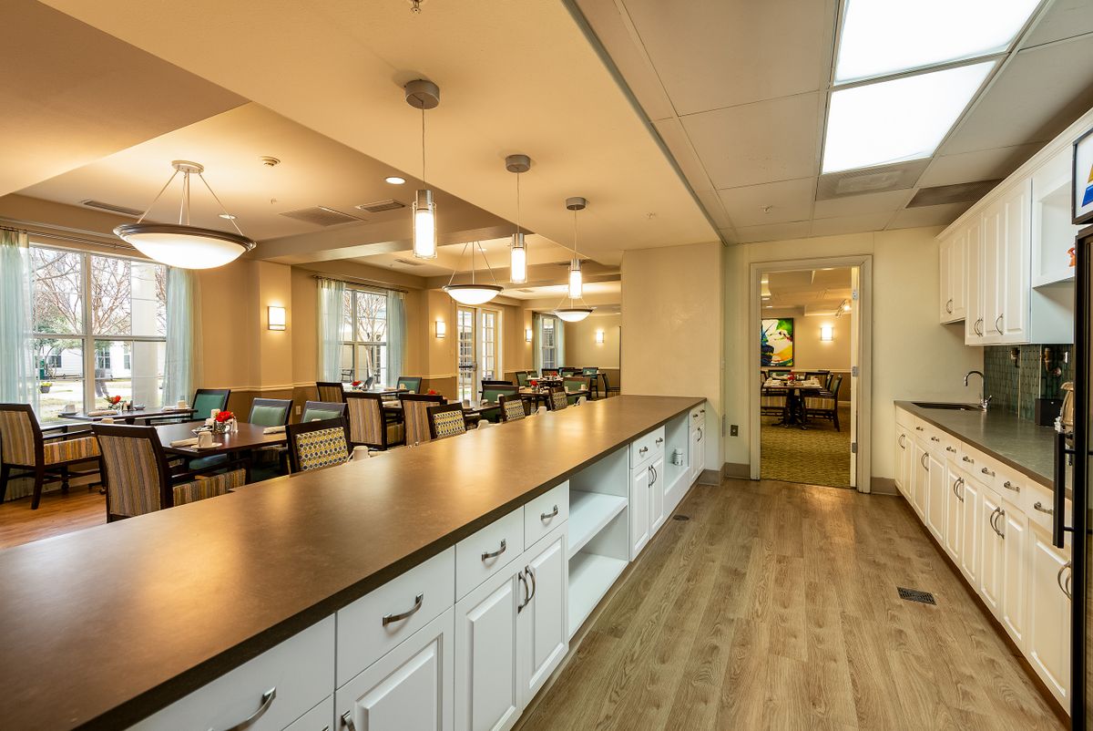 A modern dining area with elegant lighting and hardwood flooring.