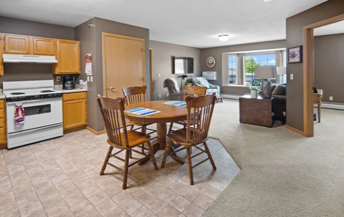Open concept living room and dining area with wooden furniture.