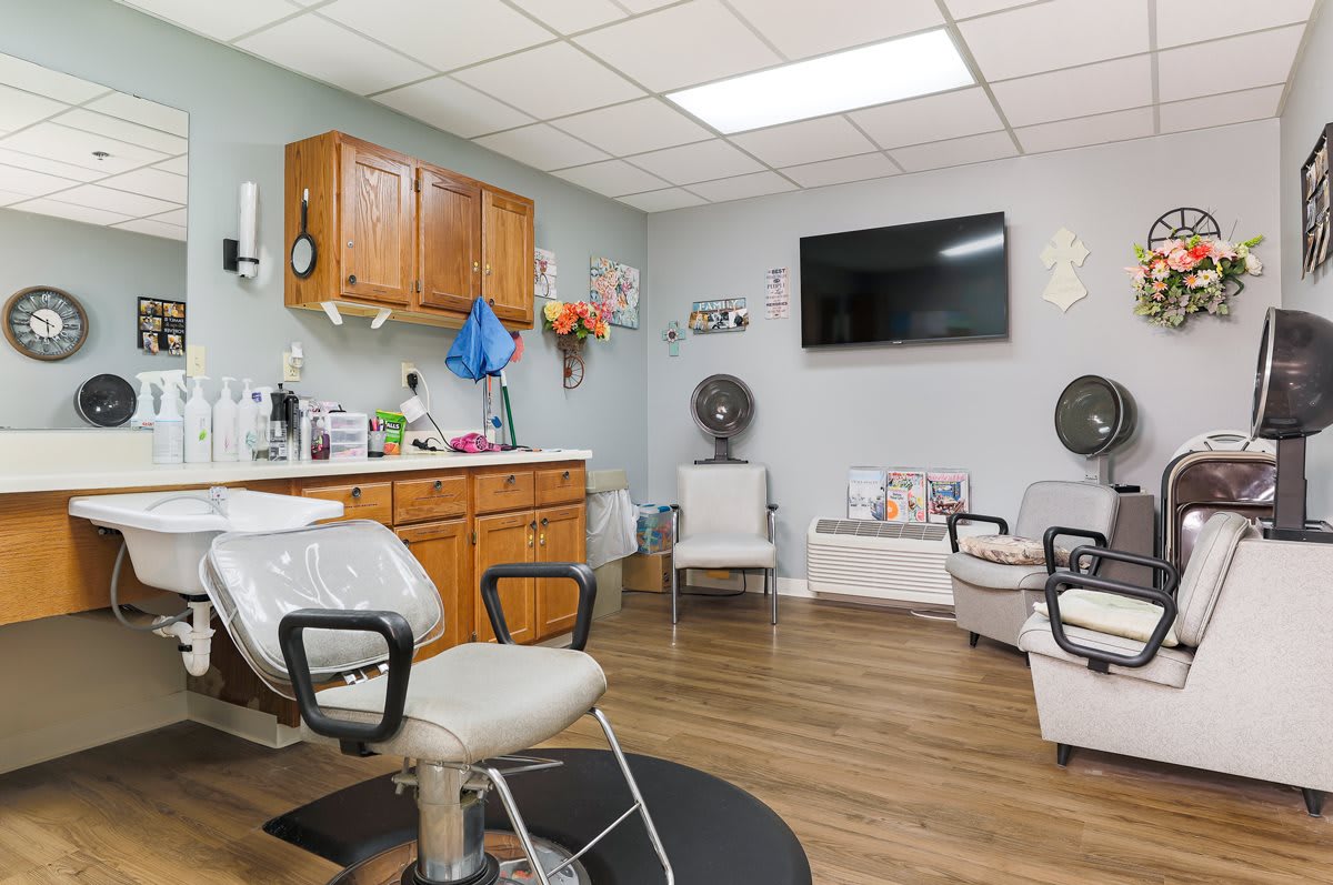 Cozy hair salon interior with styling chairs and a waiting area.