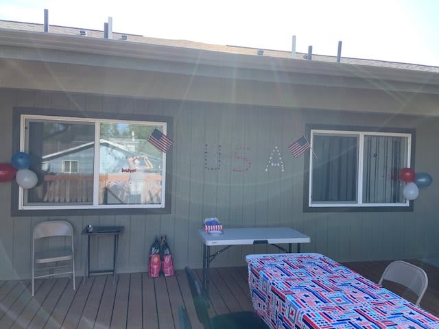 A backyard setup with tables and party decorations.