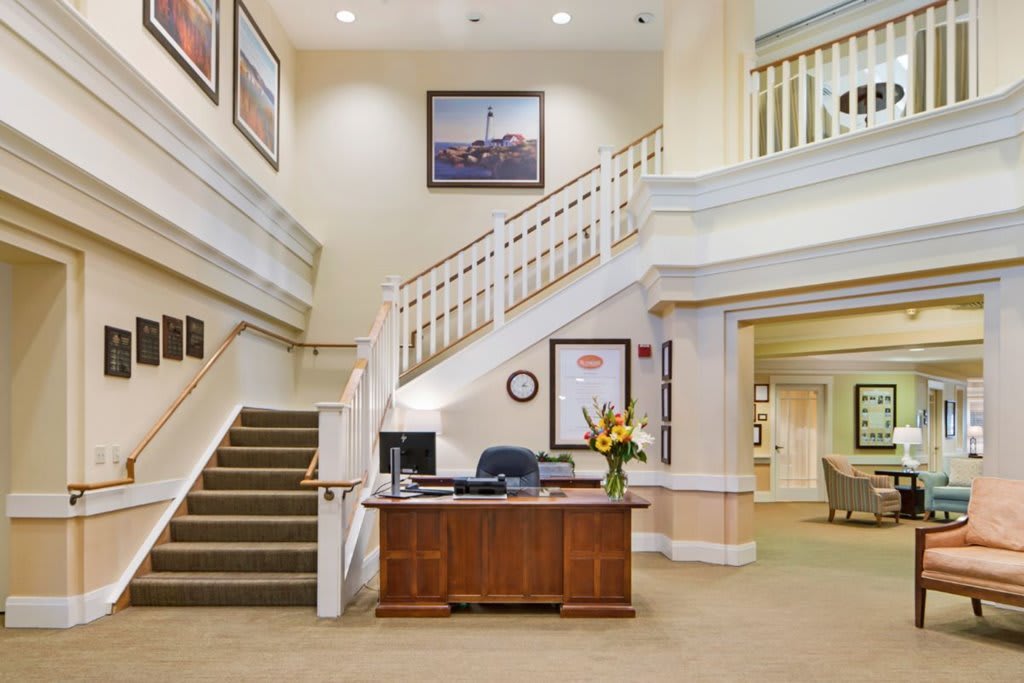 A welcoming lobby with a reception desk and staircase.