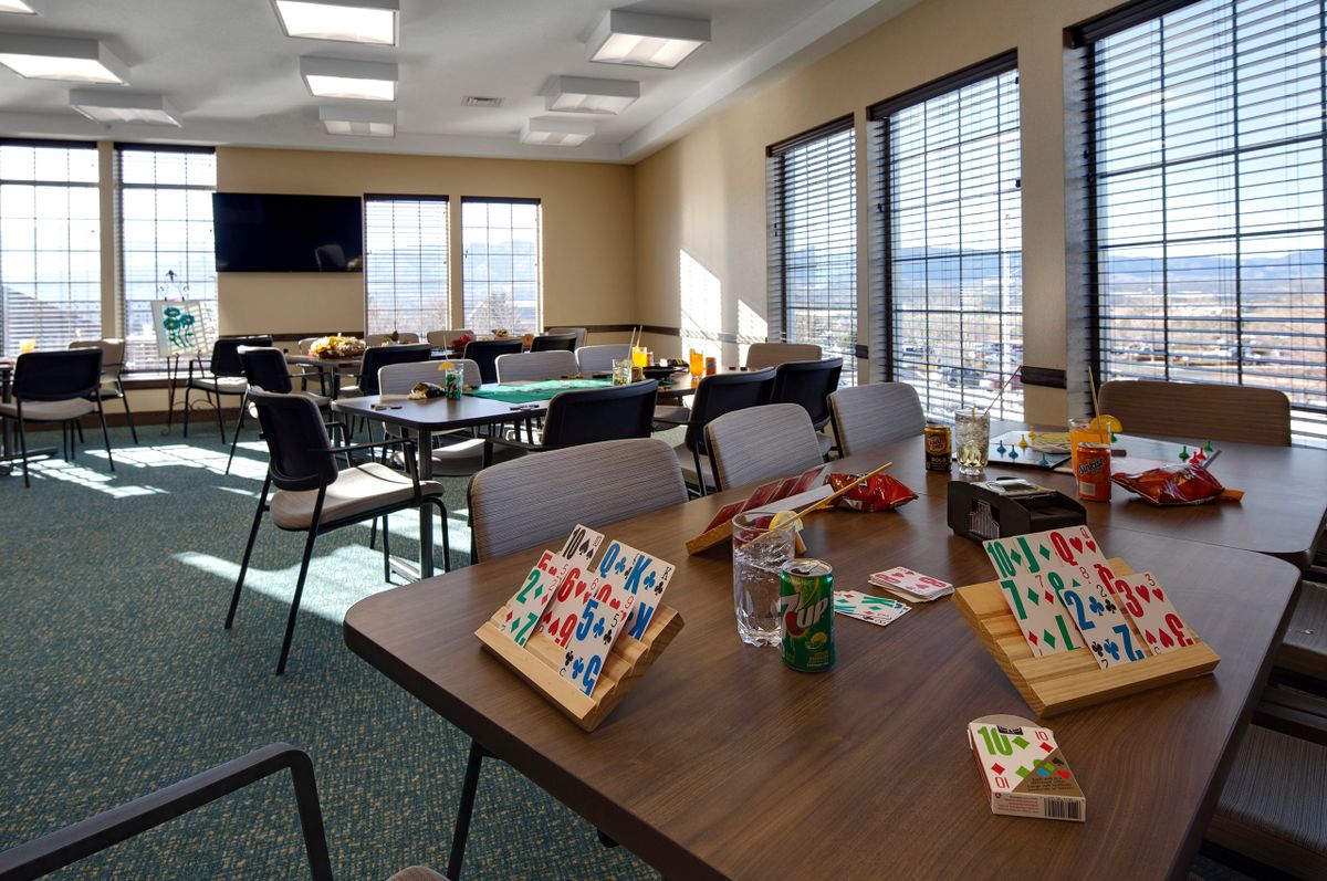 A bright community center room set up for a bingo game, with tables and chairs arranged neatly.