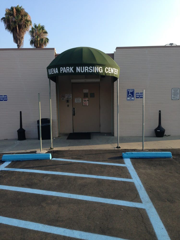 Entrance to a nursing center with designated handicap parking.