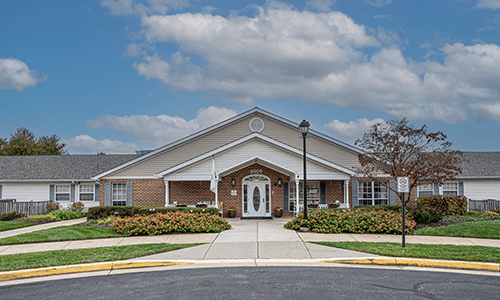 A suburban-style residential building with a well-maintained entrance and landscaping.