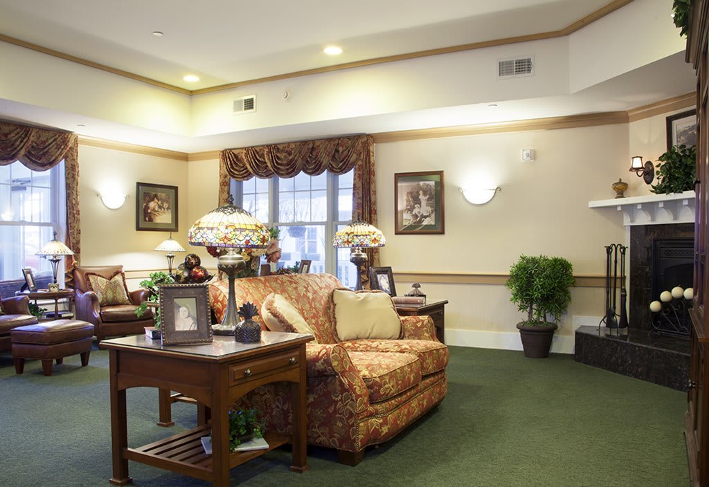 A cozy, well-decorated living room with comfortable seating and elegant decor.
