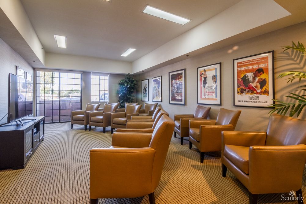 A comfortable lobby featuring leather chairs and decorative artwork on the walls.