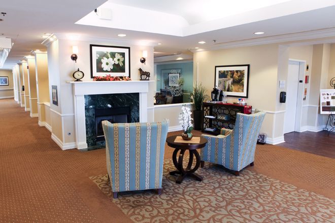 A cozy lobby area with comfortable seating and a stylish fireplace.