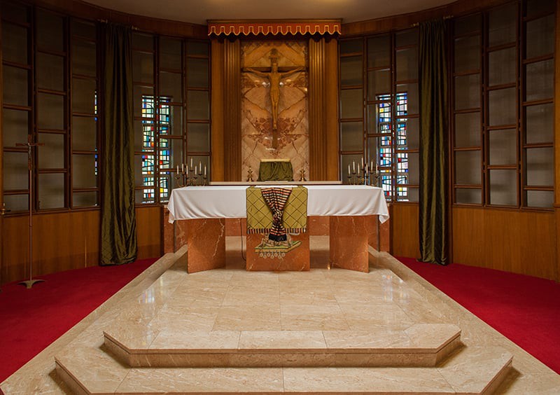 A beautifully designed church altar with intricate woodwork and religious symbols.
