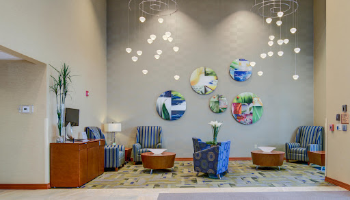 A modern lobby featuring stylish seating, artistic wall decor, and contemporary lighting.