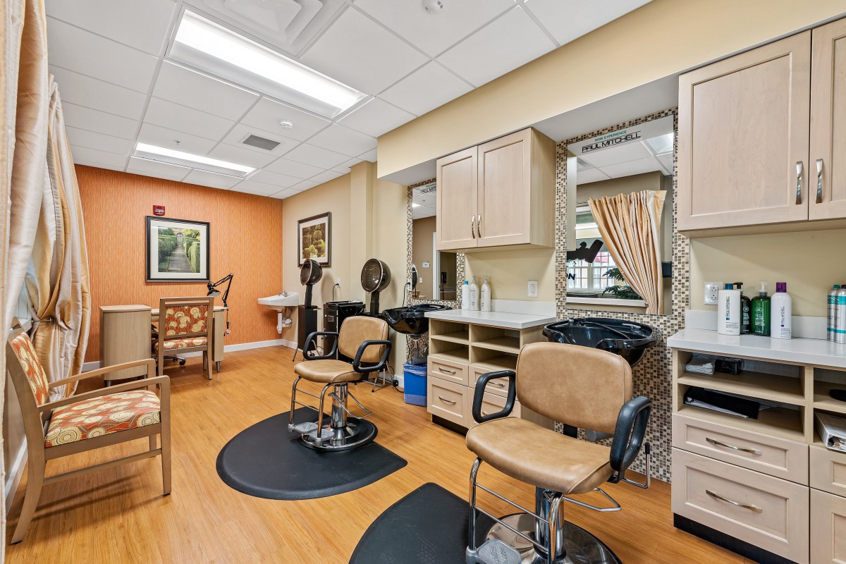 A modern beauty salon interior with styling chairs and mirrors.