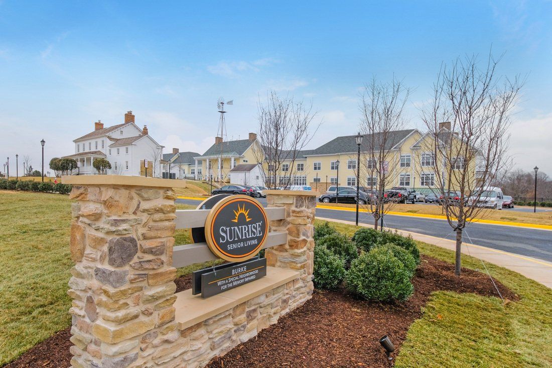A suburban neighborhood with neatly landscaped surroundings and a welcoming entrance sign.