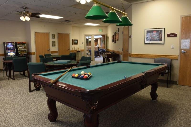 A cozy game room featuring a billiards table with pool balls set up for play.