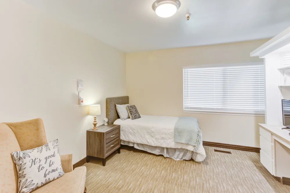 A minimalist bedroom with a single bed and nightstand.