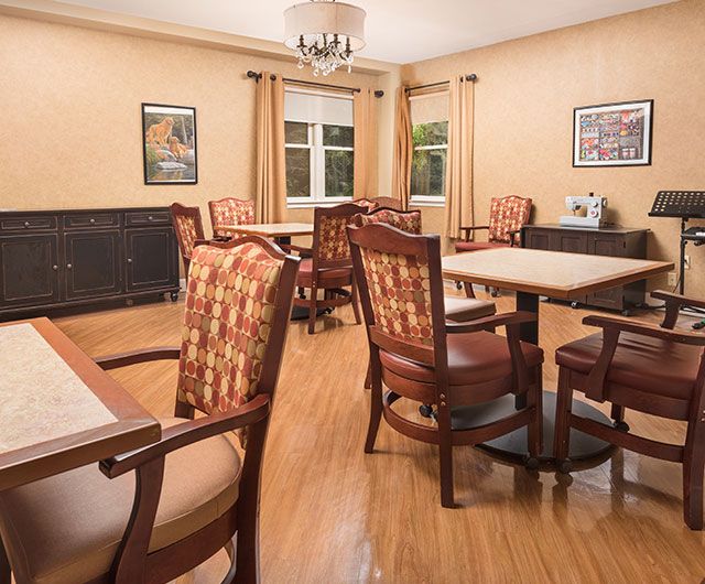 A cozy dining room with elegant wooden furniture and warm lighting.