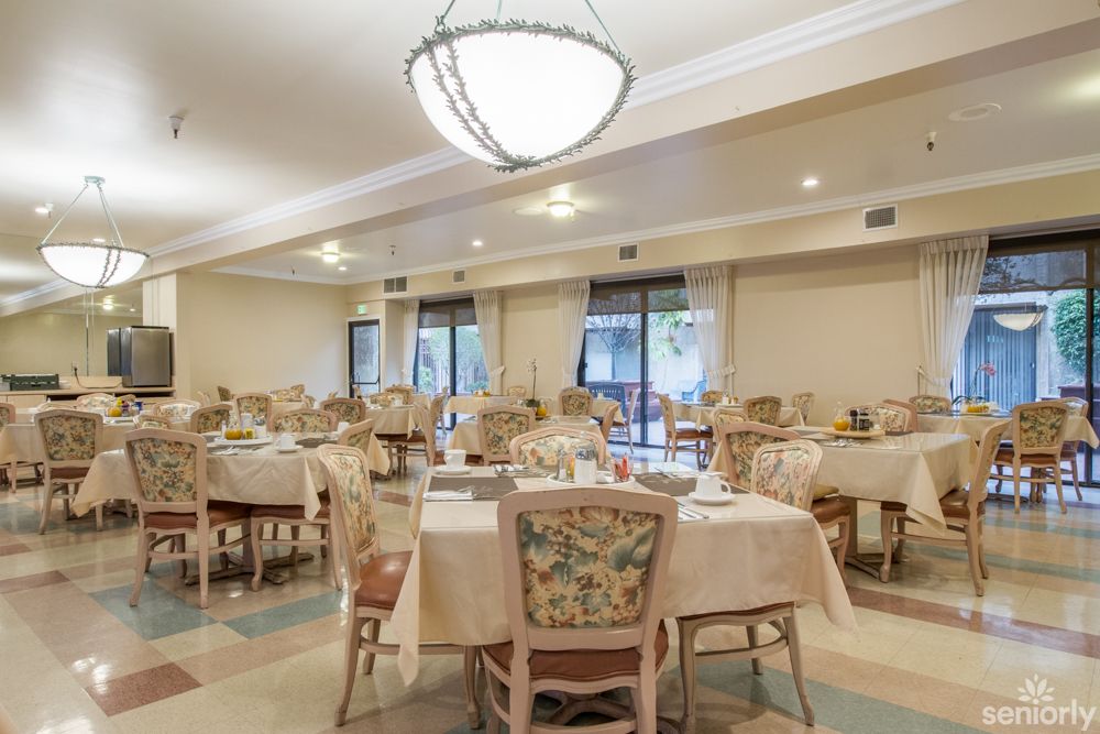 An elegantly decorated dining room with empty tables and chairs.