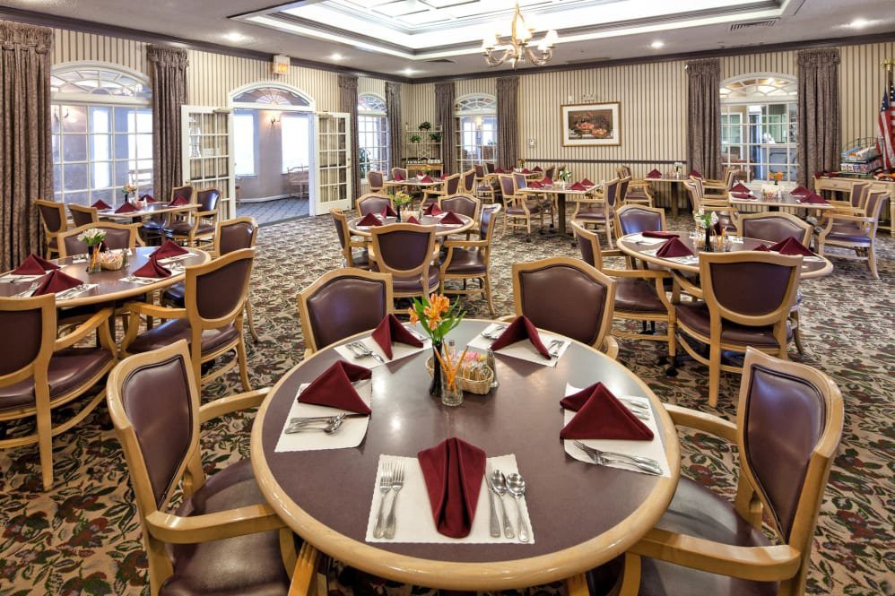 A well-arranged dining area with neatly set tables and chairs.