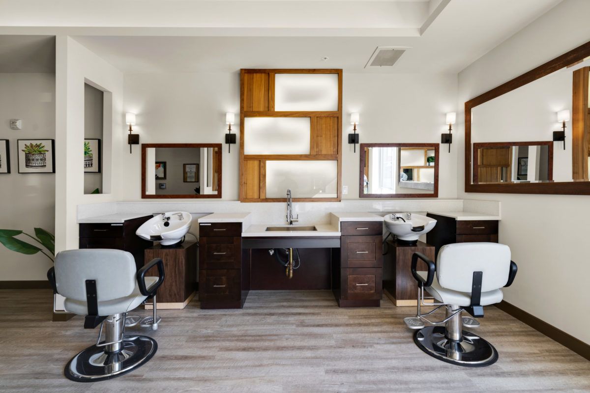 A modern hair salon interior with stylish barber chairs and wooden accents.