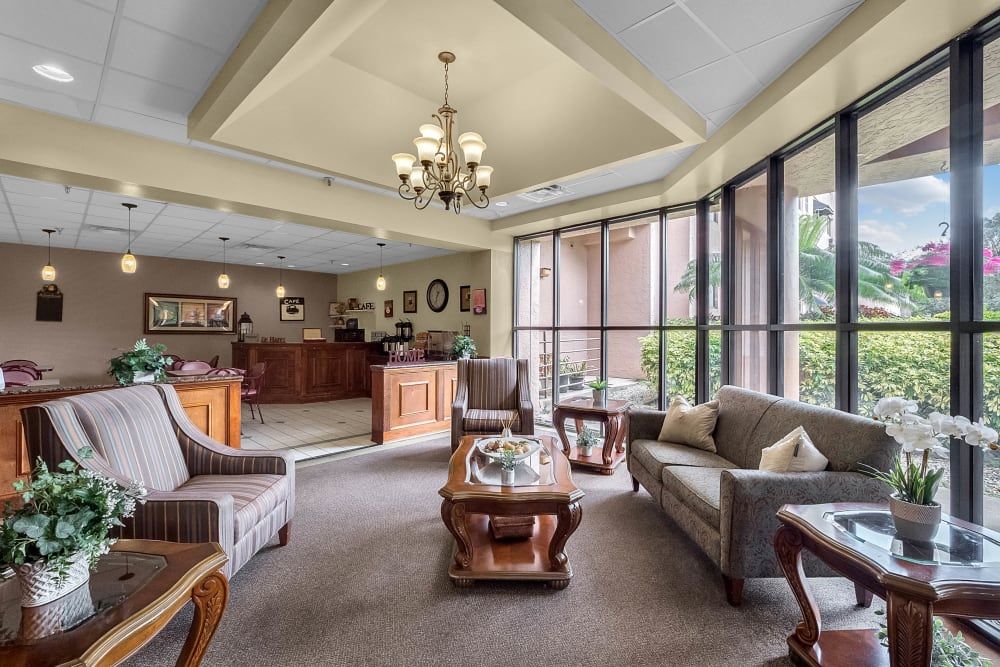 A well-furnished lobby with comfortable seating and large windows.