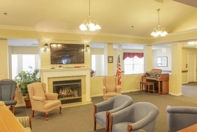 A cozy living room with comfortable seating, a fireplace, and a television.