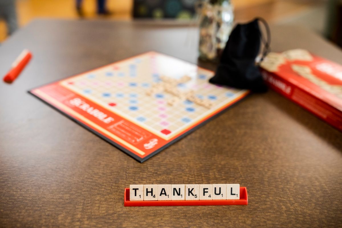 A Scrabble game with the word 'THANKFUL' spelled out on the tiles.