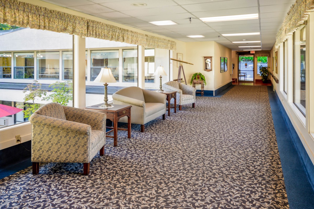 A spacious lobby with comfortable seating and a patterned carpet.