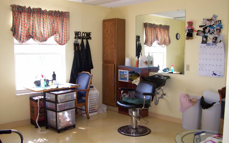 Interior view of a hair salon with styling stations and chairs.