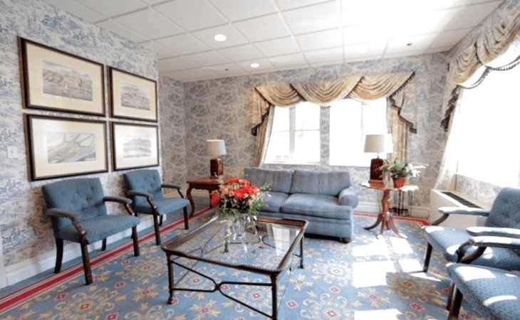 A cozy living room with elegant furniture and floral decor.