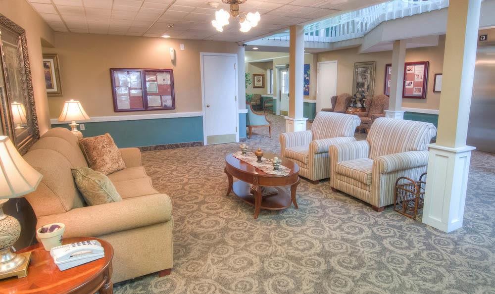 A cozy living room with comfortable seating and a carpeted floor.