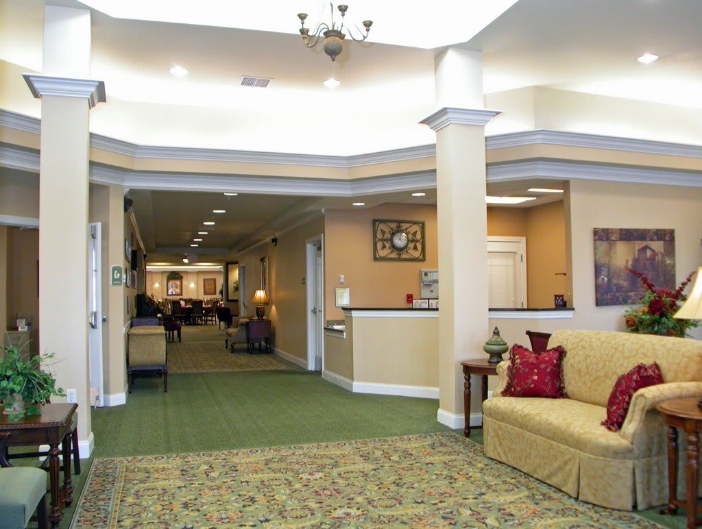 A spacious lobby area with a seating arrangement and decorative lighting.