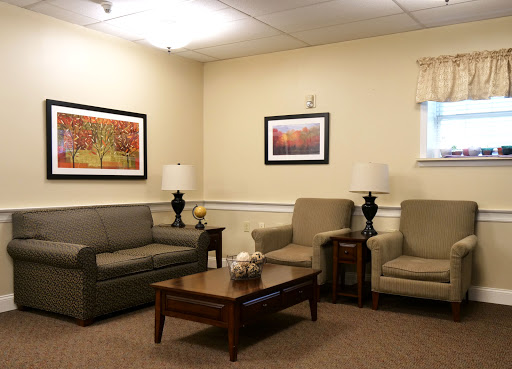 A cozy living room setting featuring comfortable seating and decorative art.