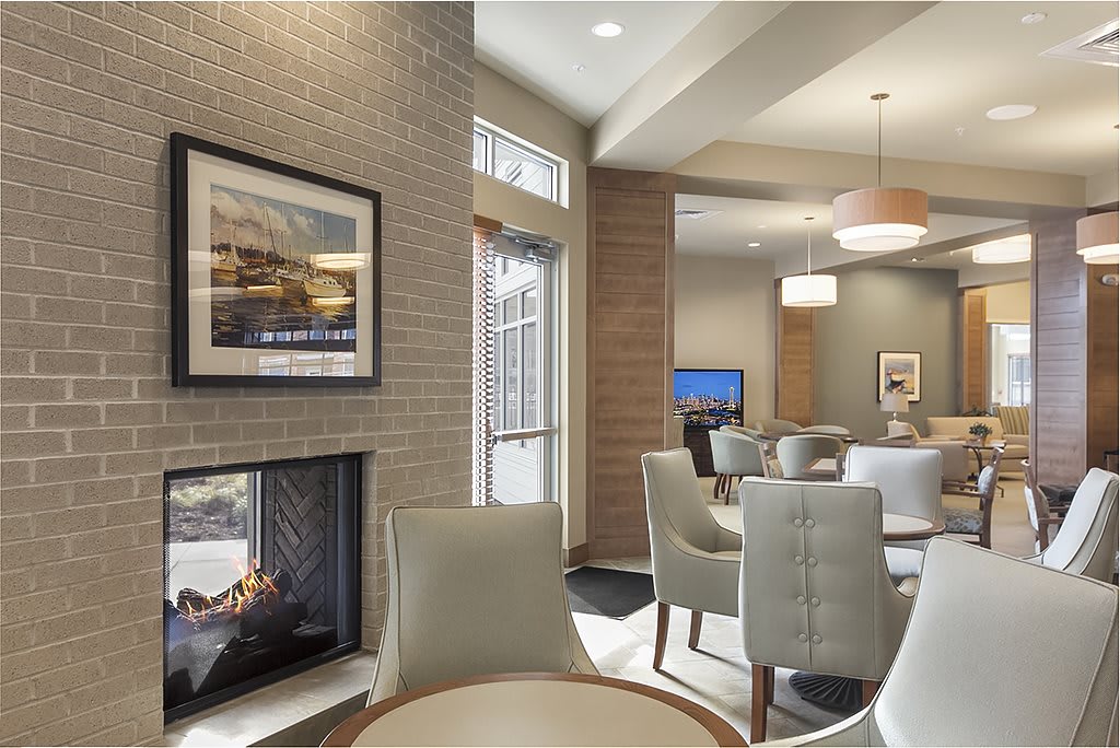 A modern lobby area featuring comfortable seating, a fireplace, and contemporary decor.