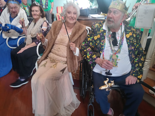 A joyful moment at a festive gathering, featuring elegantly dressed guests enjoying the celebration.