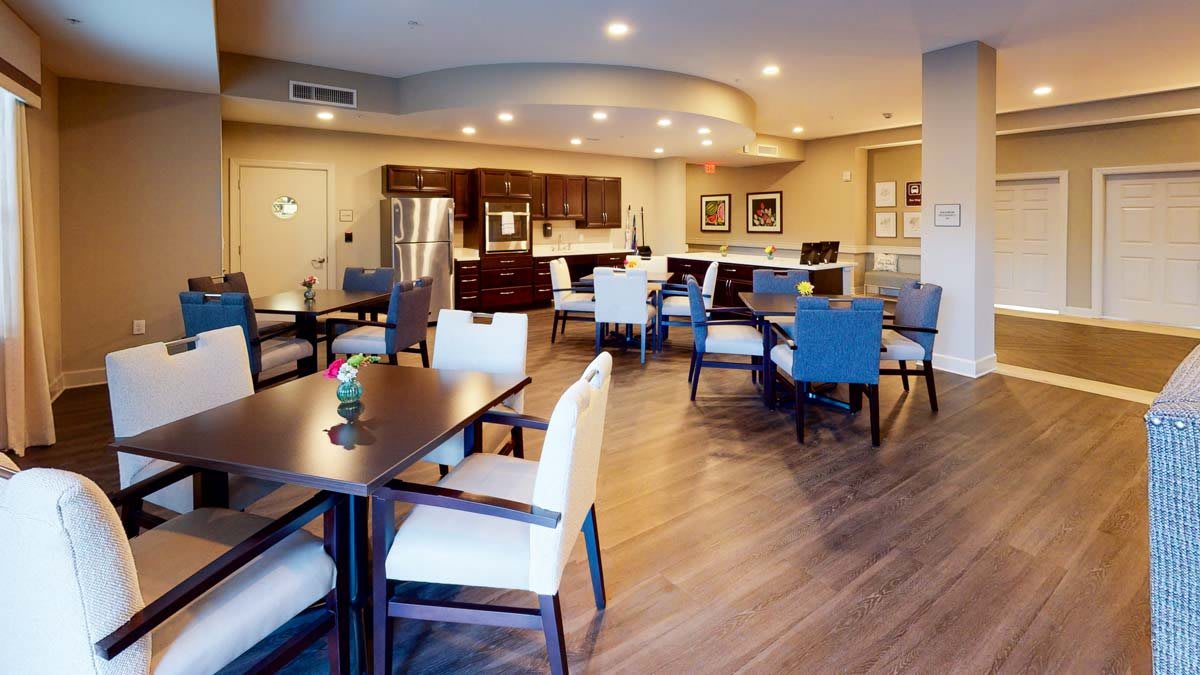 A modern dining and kitchen area with elegant furnishings and warm lighting.