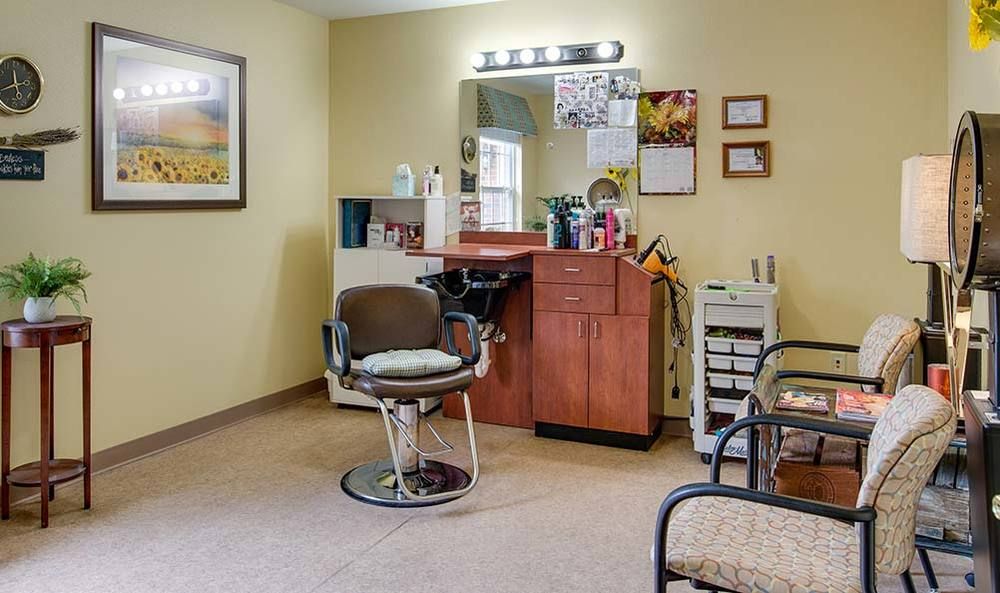 A cozy salon interior with a styling chair, mirror, and beauty station.
