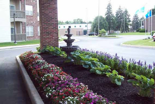 A beautifully landscaped garden featuring vibrant flowers and a charming fountain.