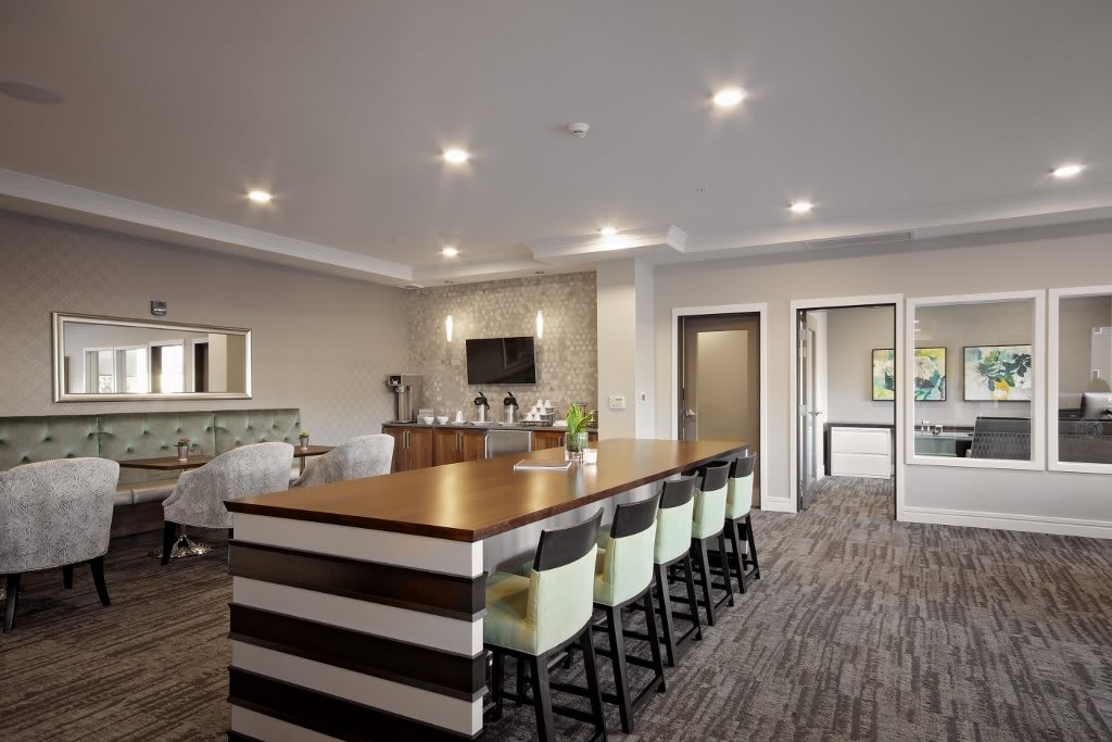 Modern kitchen interior with a large island and seating area.