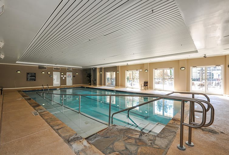 A luxurious indoor swimming pool with modern design and relaxing ambiance.