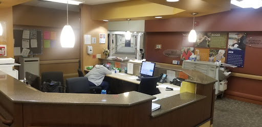 A view of the hospital reception area with staff members attending to duties.