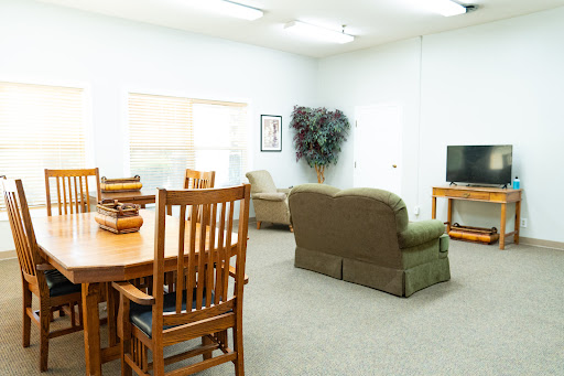 A spacious and modern living room featuring comfortable seating and a dining area.