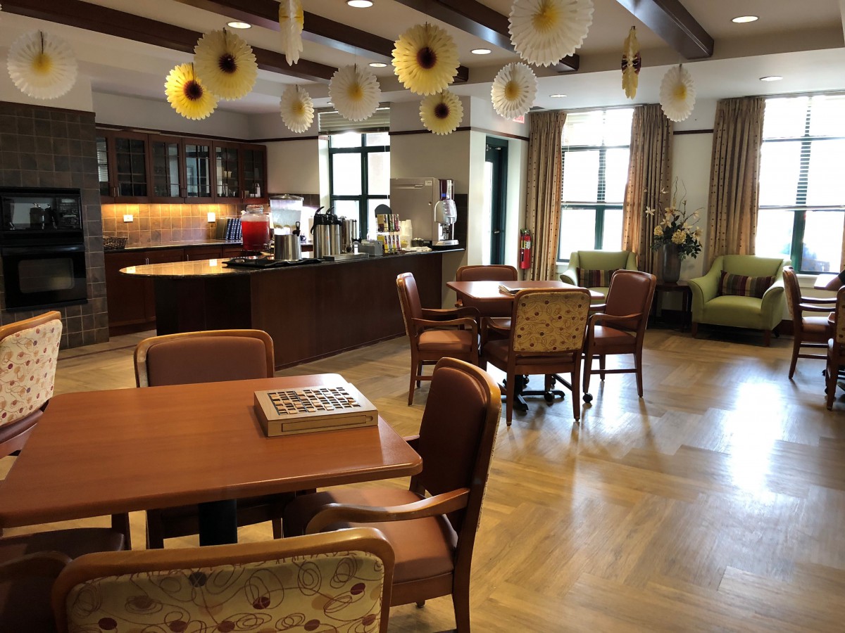 A cozy dining area with wooden tables, chairs, and charming decorations.