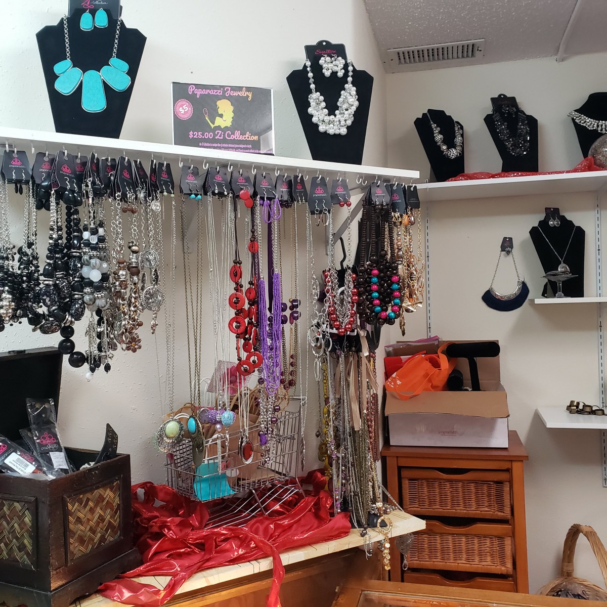 A jewelry display featuring an array of colorful necklaces and accessories in a store.