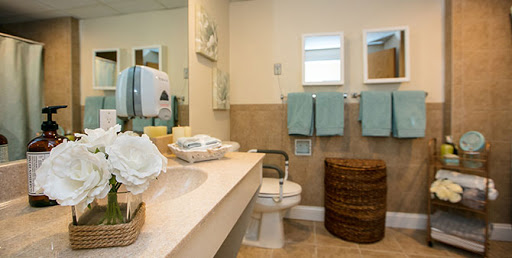 A clean and well-organized bathroom featuring towels, a sink, and decorative accents.
