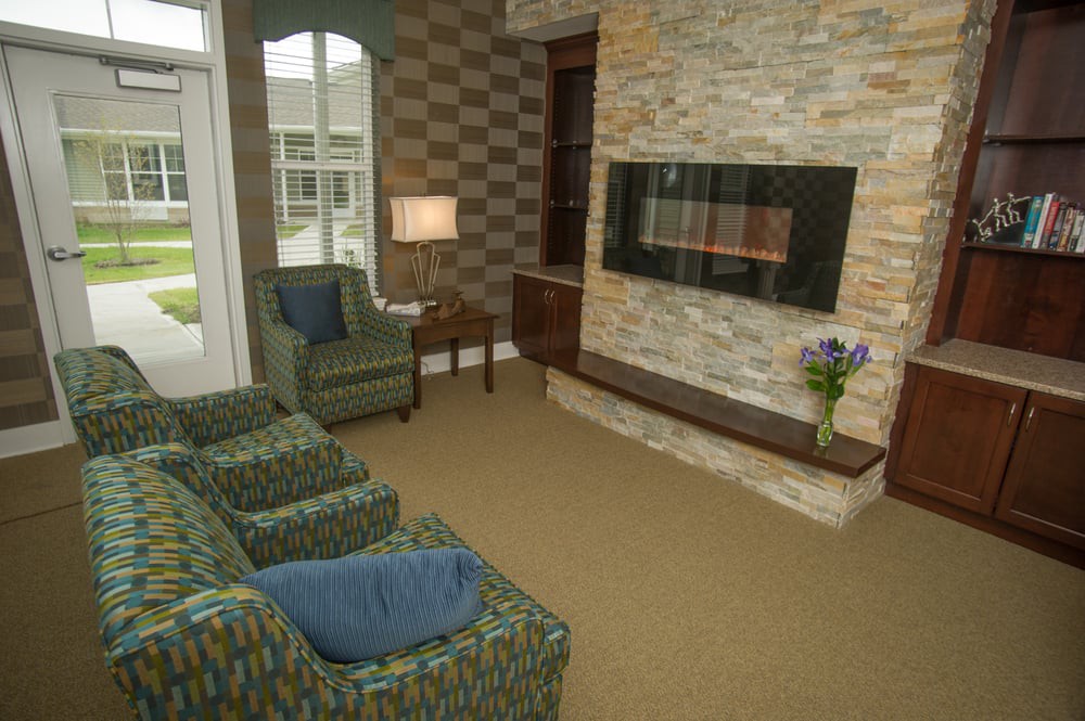 A cozy living room with a modern fireplace and comfortable seating.