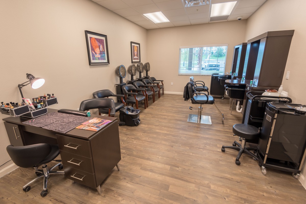 An interior view of a modern hair salon with styling chairs and mirrors.