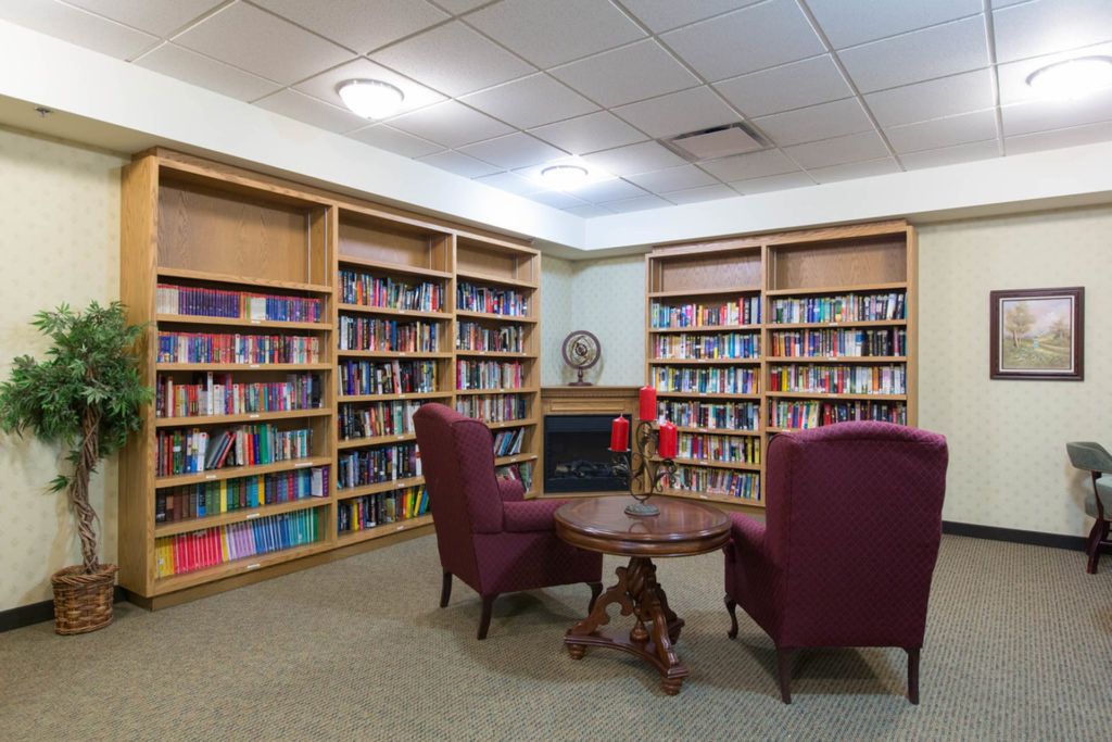 A cozy library corner with bookshelves and seating for reading.
