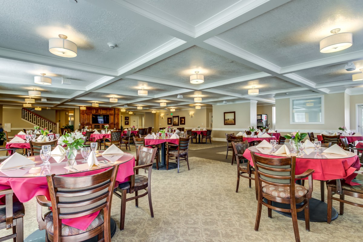 An elegant dining area with neatly arranged tables and chairs, featuring a warm and inviting atmosphere.