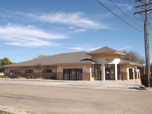 A modern commercial building set against a clear blue sky.
