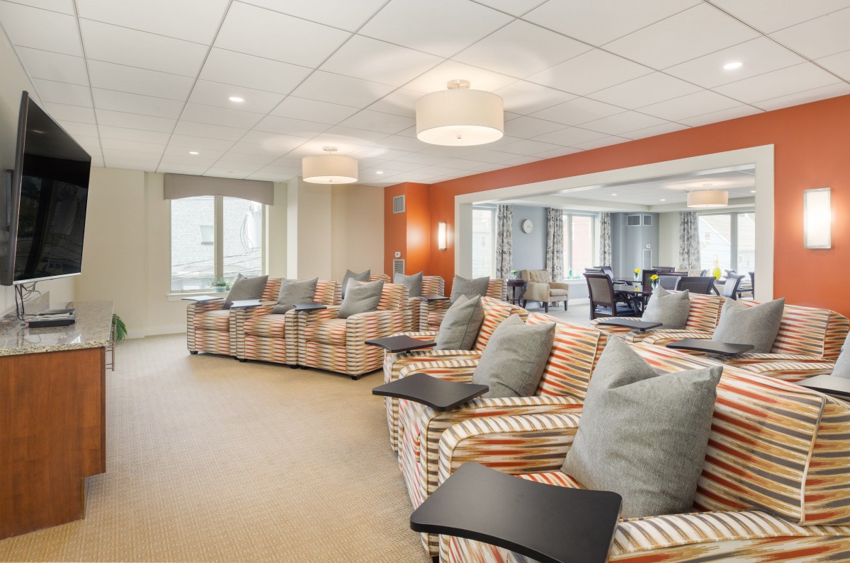A modern seating area with striped chairs and ample lighting.