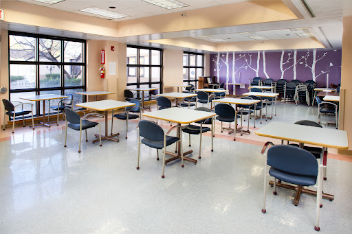 An empty classroom setup with tables and chairs, ready for an educational session.