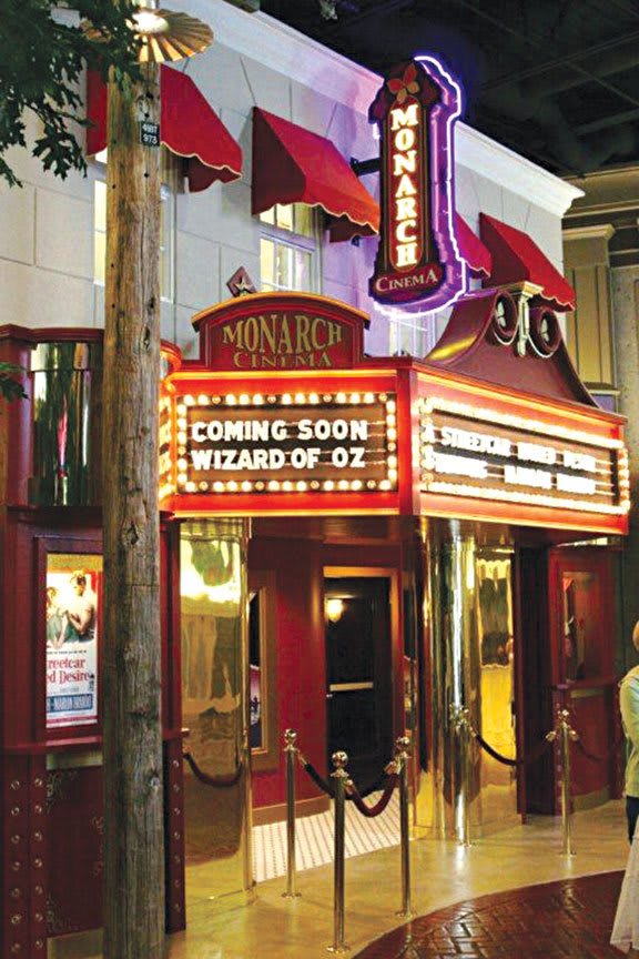 Theater marquee announcing 'Coming Soon: Wizard of Oz'.
